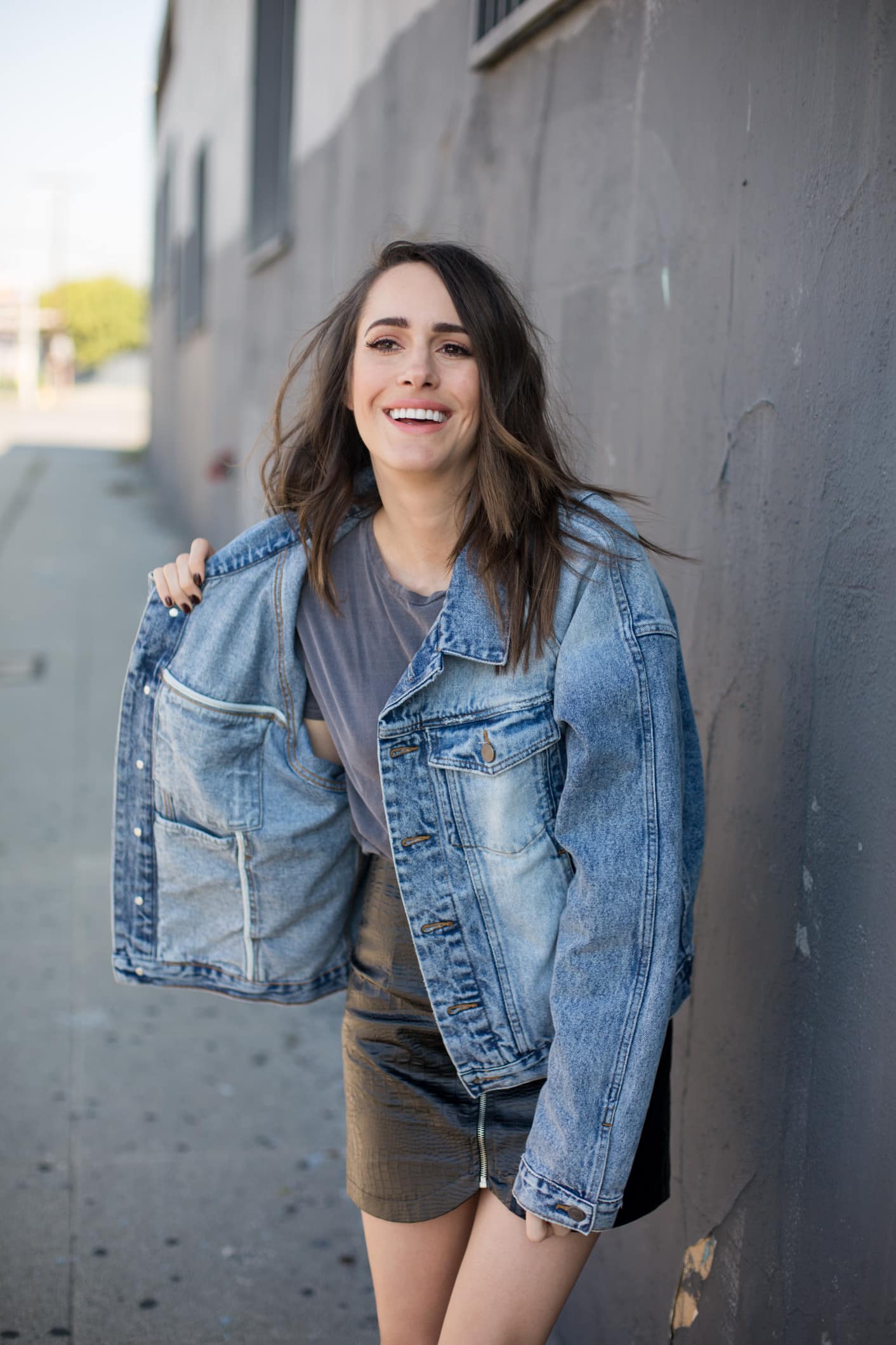 Louise Roe wearing a denim jacket and leather skirt