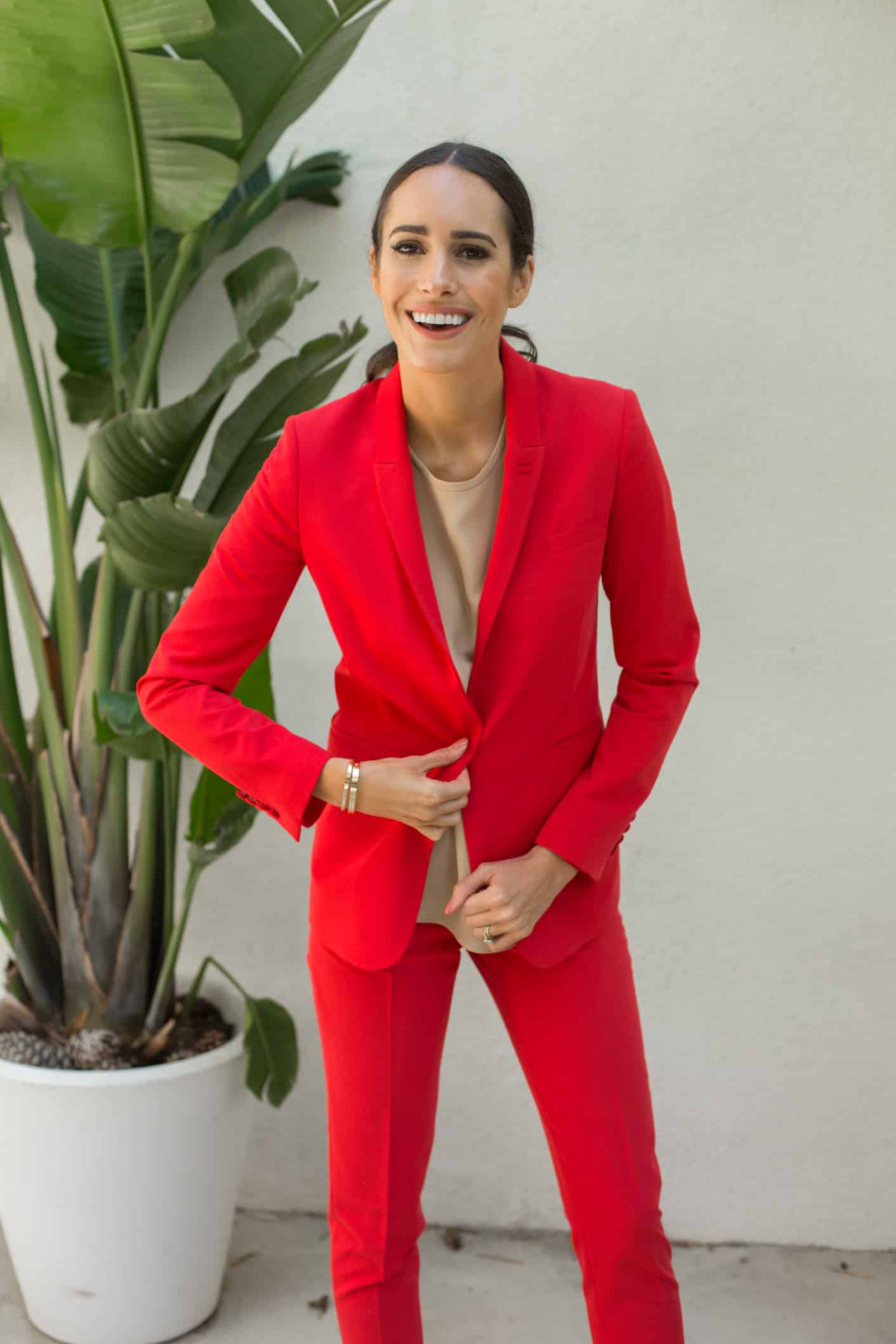 Louise Roe wearing a red power suit