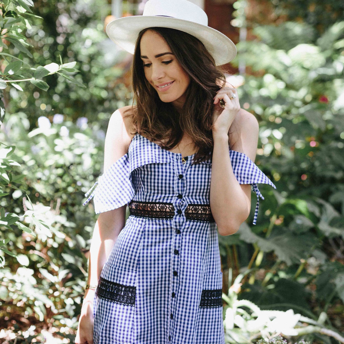 Louise Roe wearing a gingham dress and hat in Santa Barbara
