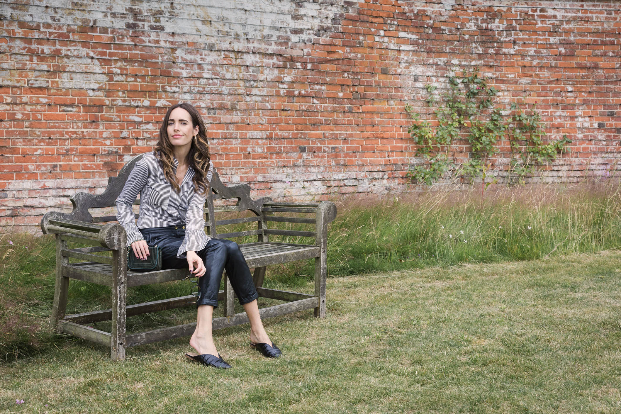 Louise Roe showcases a chic work outfit featuring leather pants and a striped blouse