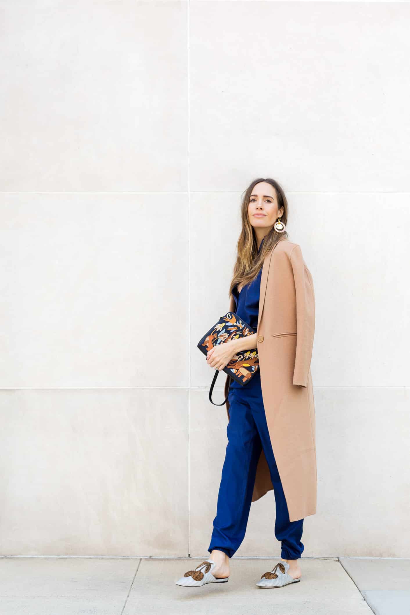 Louise Roe wearing a camel coat and blue pantsuit for fall