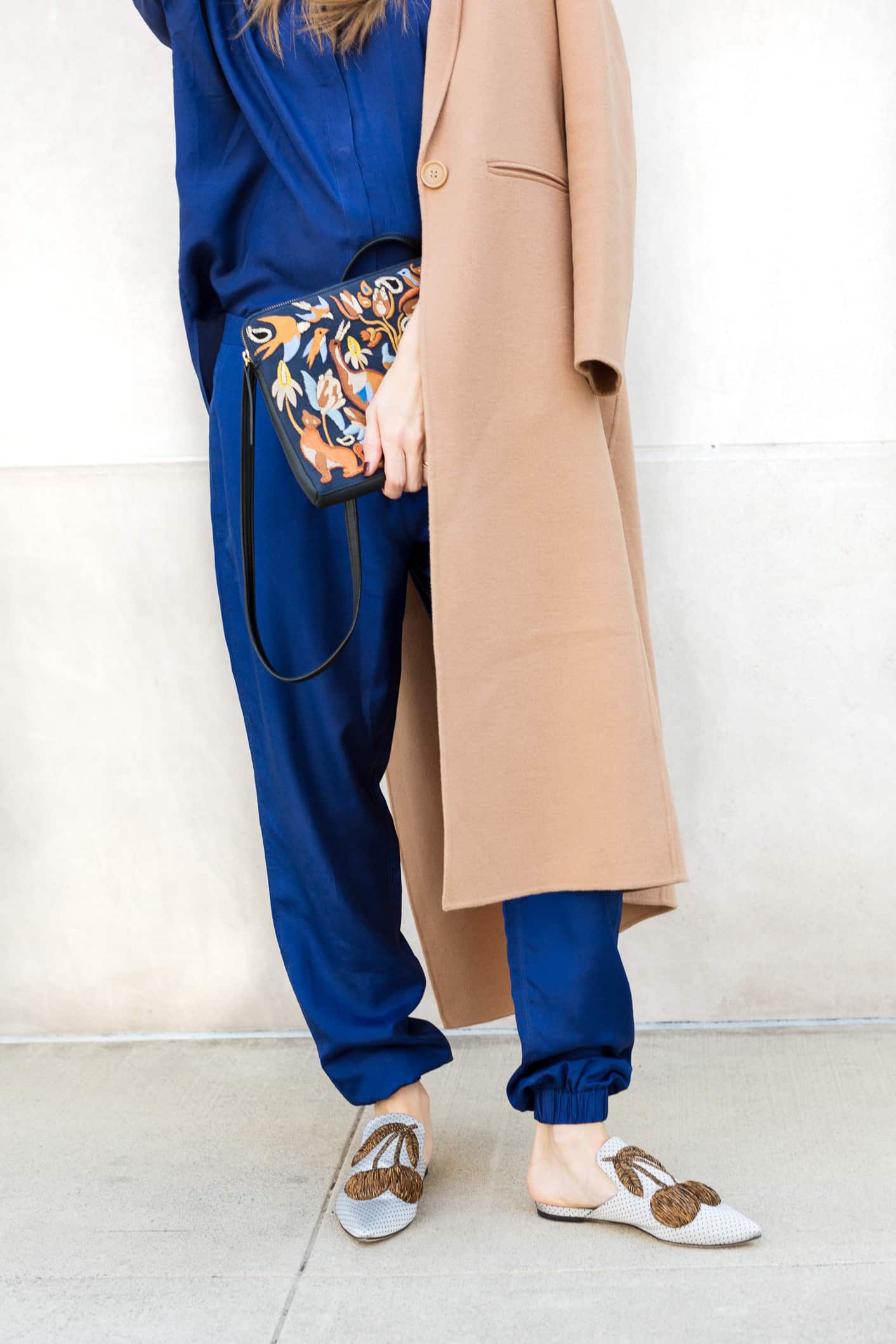 Louise Roe wearing a camel coat and blue pantsuit for fall