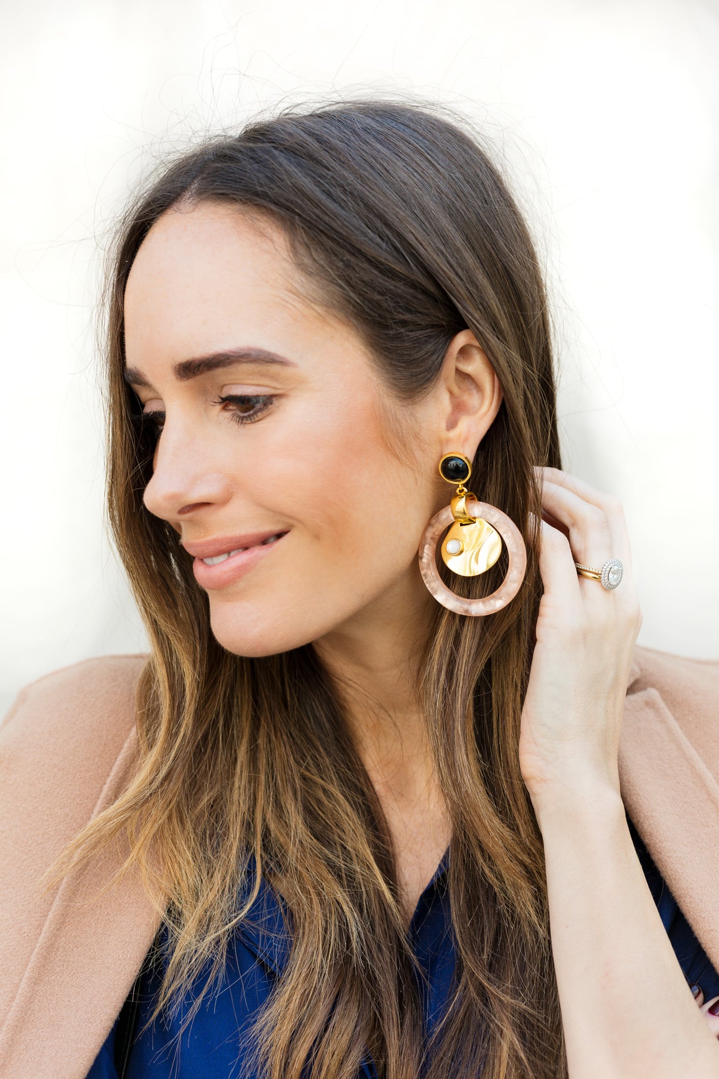 Louise Roe wearing a camel coat and blue pantsuit for fall