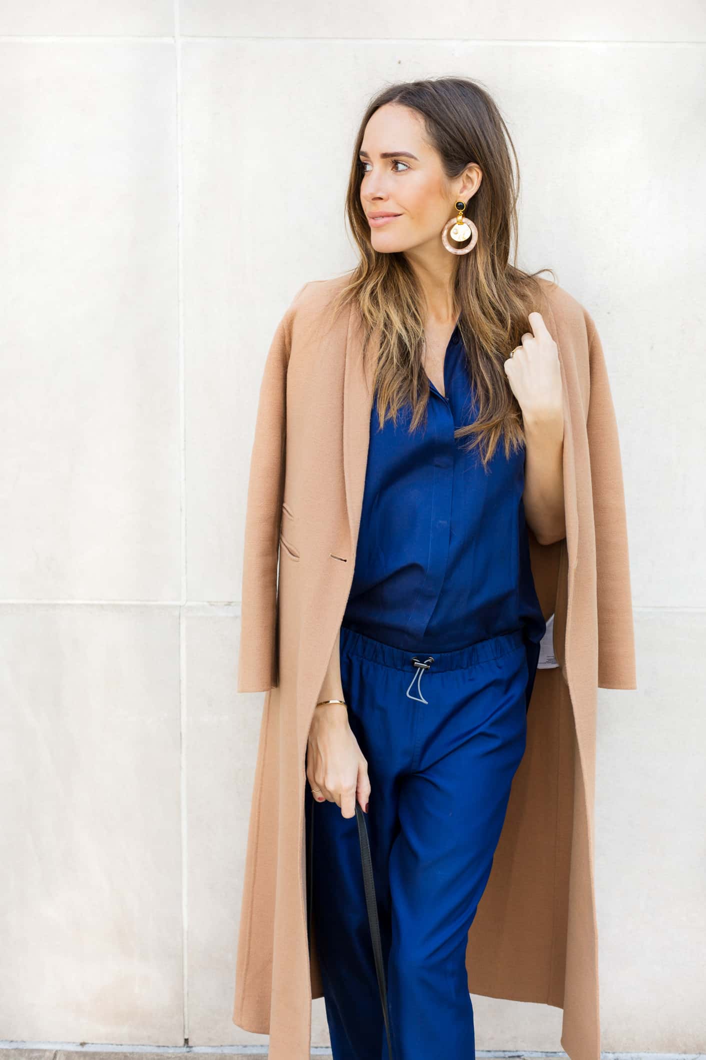 Louise Roe wearing a camel coat and blue pantsuit for fall