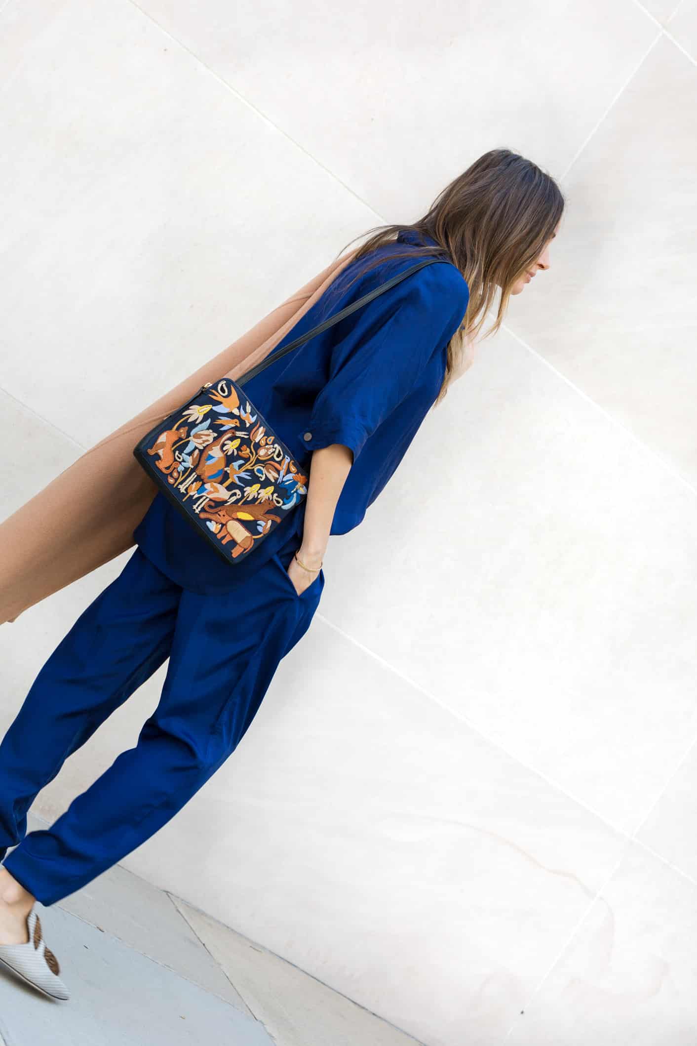 Louise Roe wearing a camel coat and blue pantsuit for fall