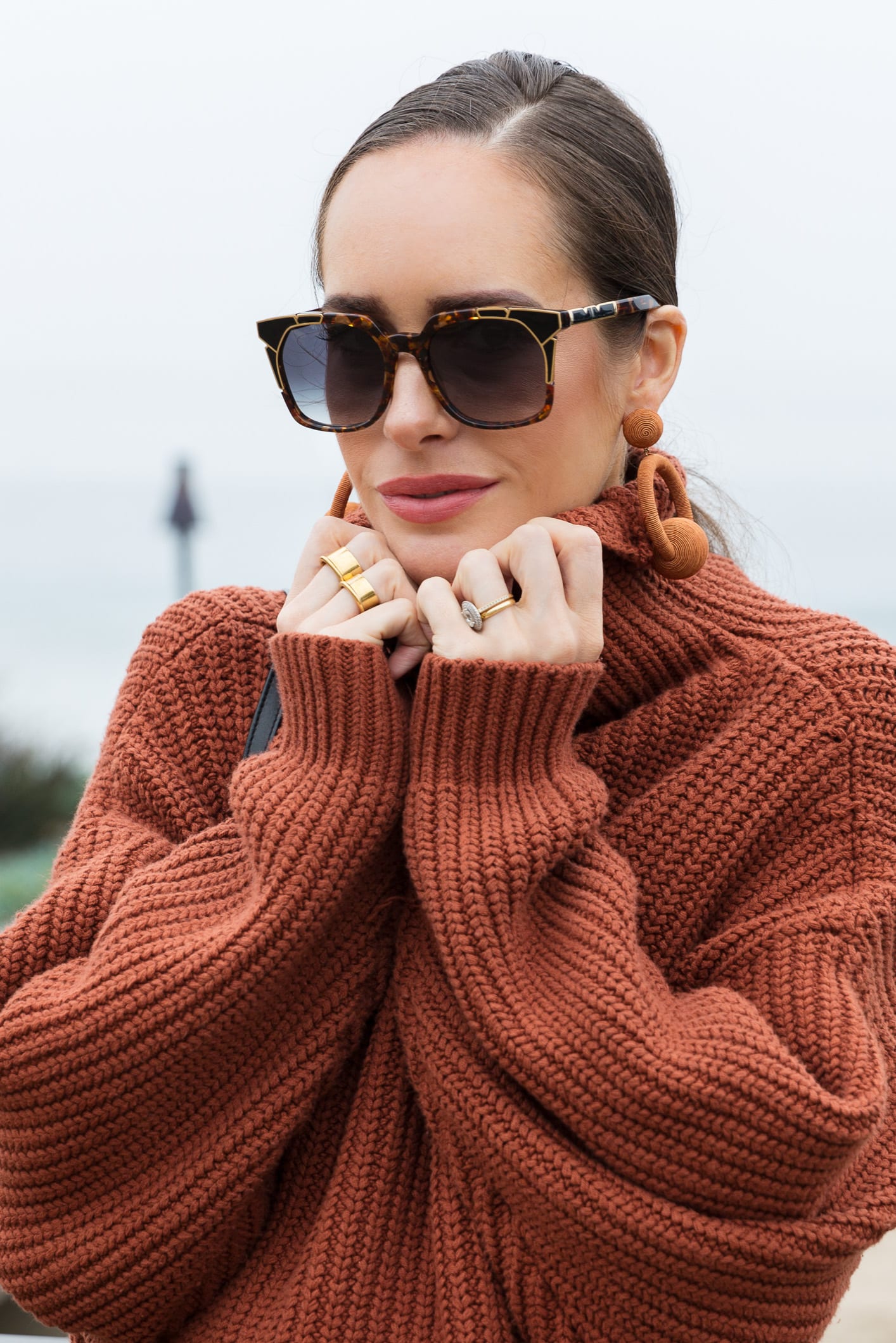Louise Roe Talks About Self Love Wearing Free People Turtleneck Madewell Jeans Rebecca De Ravenel Earrings and Embroidered Clutch