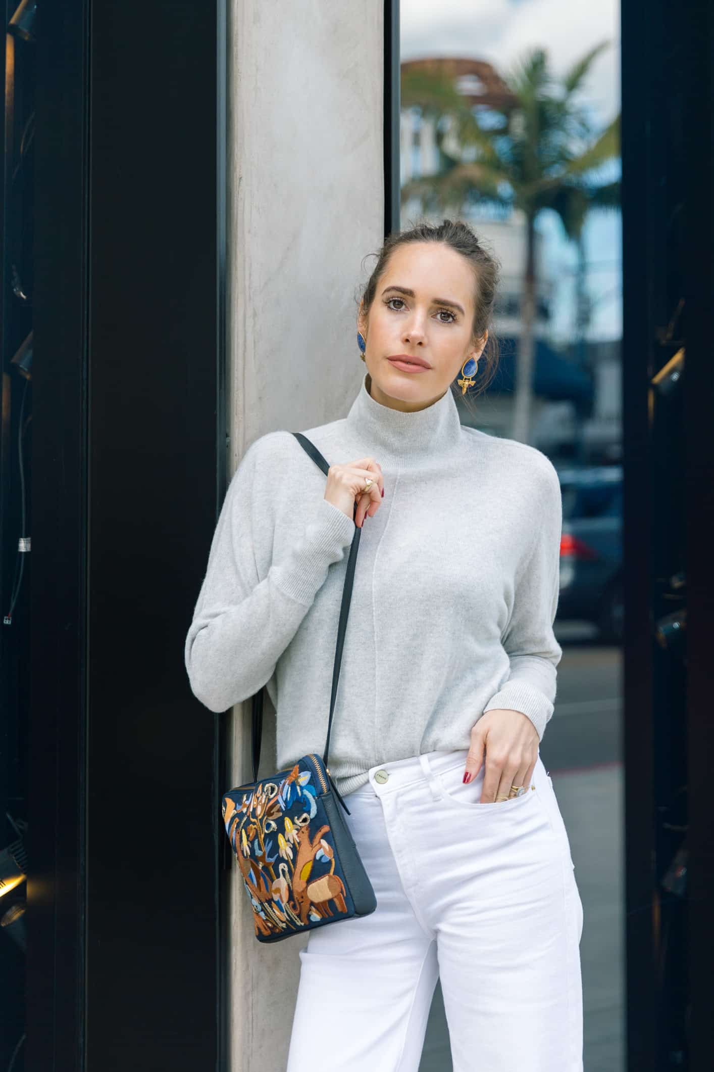 Louise Roe wearing spring denim trends with white jeans and snakeskin boots
