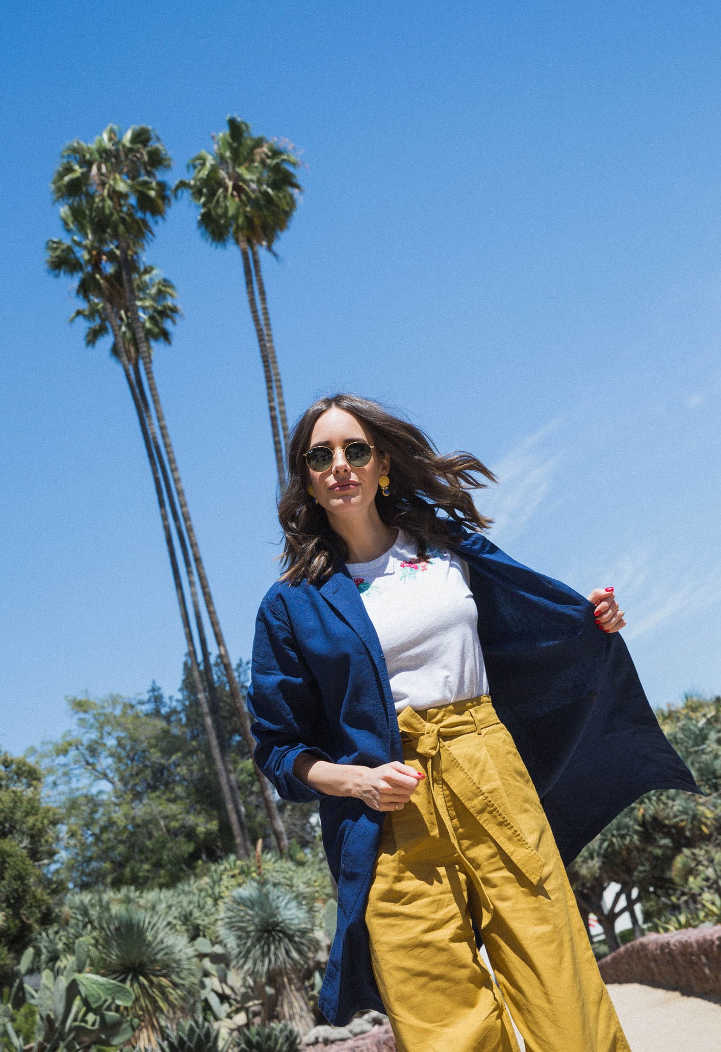 Louise Roe wearing Uniqlo x Sanderson tee mustard trousers cobalt coat and mules for Spring