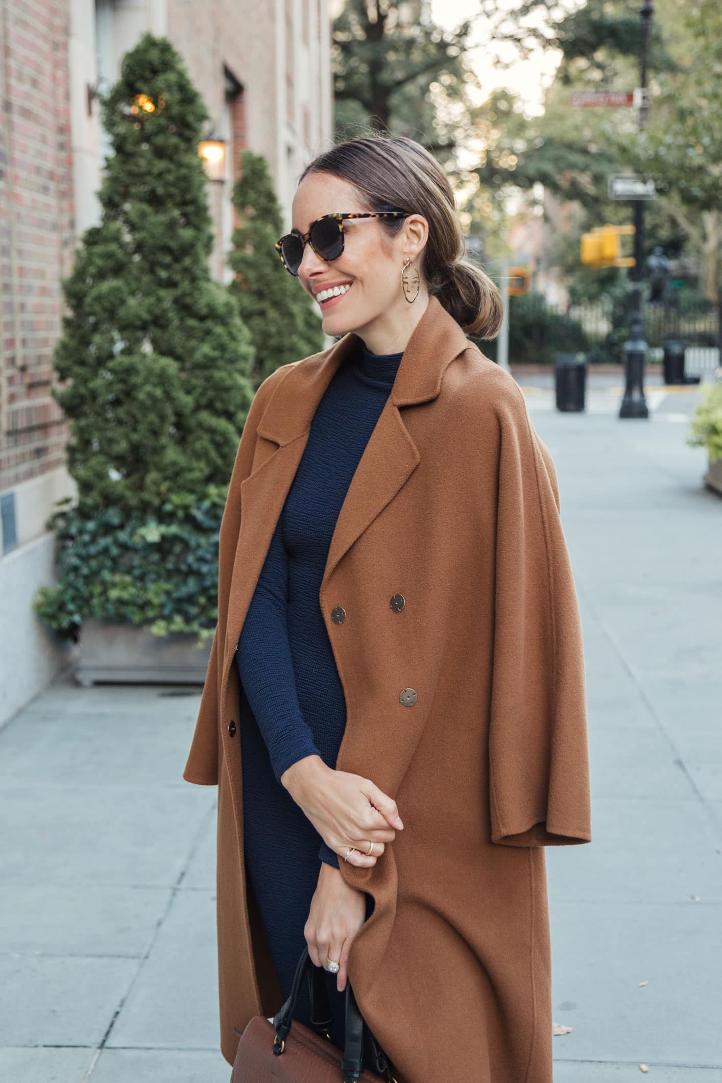Louise Roe wearing fall outfit with navy dress and camel coat