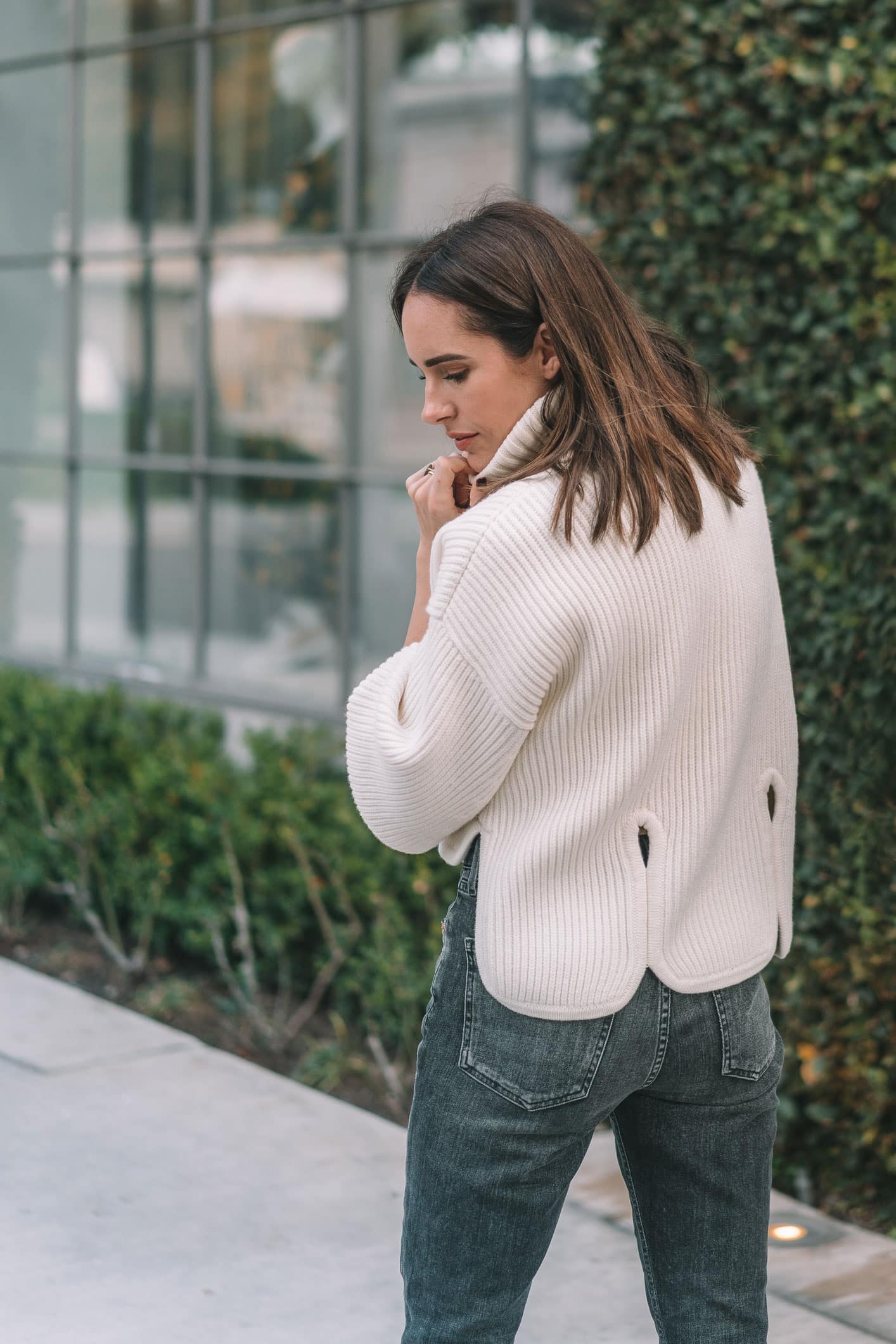 Louise Roe wearing Frame jeans ivory sweater and Jimmy Choo statement heels